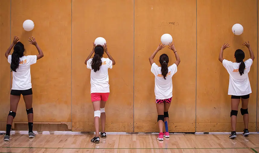 Players practicing volleyball skills